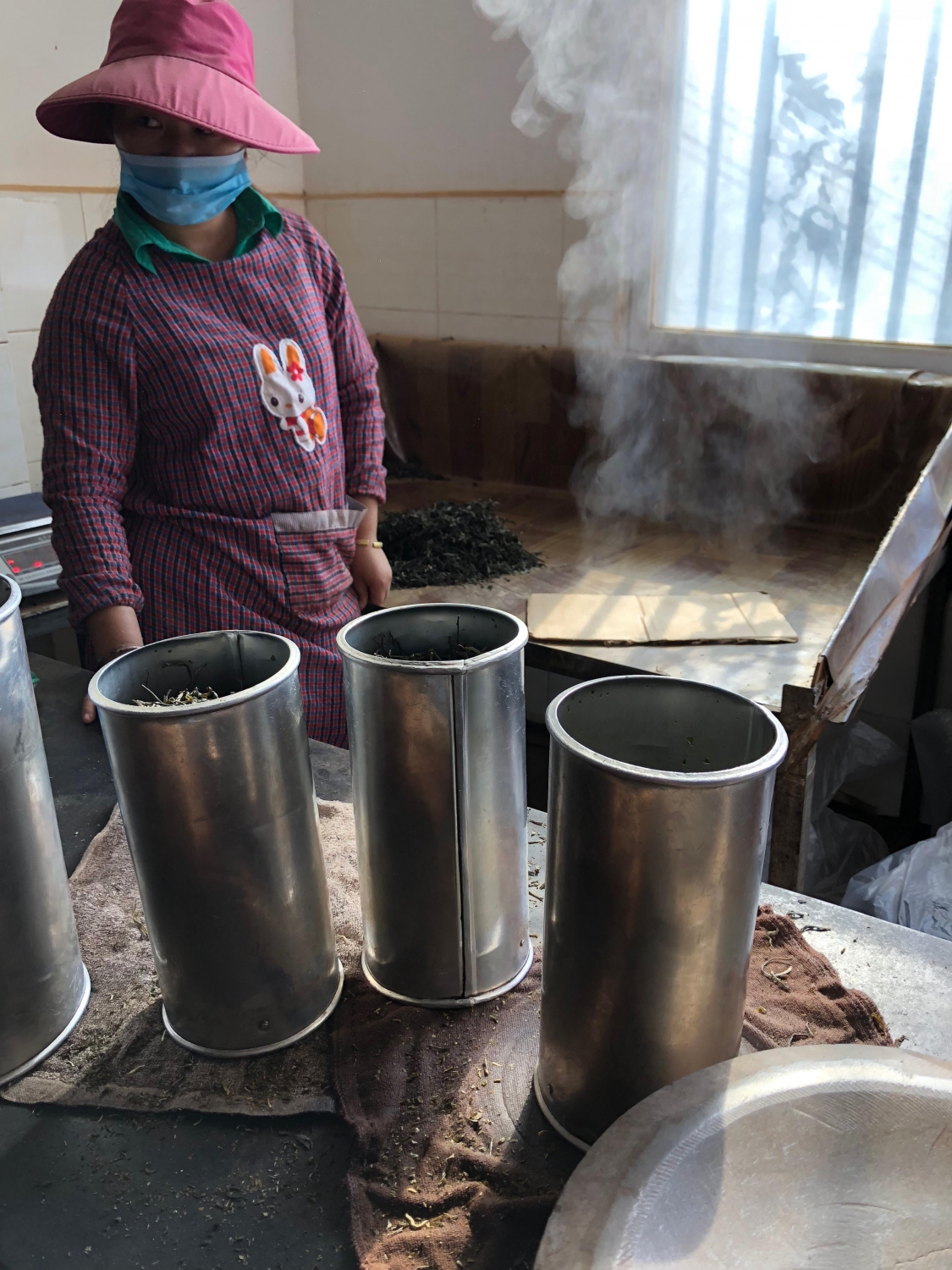 Steaming cylinders filled with Pu'er mao cha awaiting steaming and shaping
